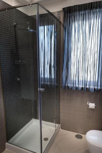 a shower with a glass door in a bathroom at Villa Caribe Resort & Spa in Spigno Saturnia