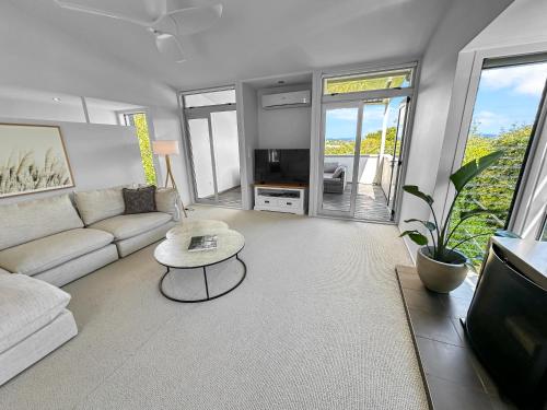 a living room with a couch and a coffee table at Westmere Wonder l Gorgeous 3 Bed Home inc View in Auckland