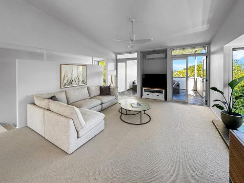 a living room with a couch and a tv at Westmere Wonder l Gorgeous 3 Bed Home inc View in Auckland