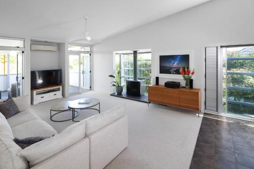 a living room with a couch and a tv at Westmere Wonder l Gorgeous 3 Bed Home inc View in Auckland