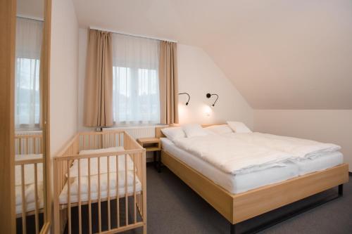 a bedroom with two bunk beds and a window at Vila Vivenot in Malá Morávka