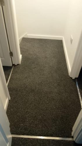 a hallway with a carpeted floor in a room at Modern 4 Bed Home, Free Parking in Hartlepool town in Hartlepool