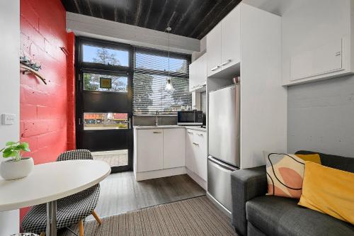 a kitchen with a couch and a table in a room at Burnie City Apartments in Burnie