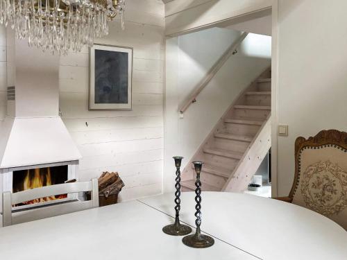 a dining room with a table and a chandelier at 4 star holiday home in VAXHOLM in Vaxholm