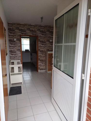 a living room with a large window and a tile floor at Ferienwohnung auf dem Land in Telgte