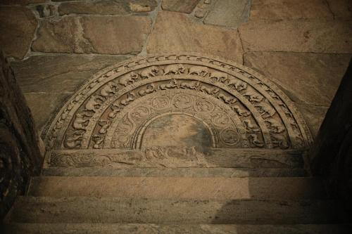 an ornate stone archway on a brick wall at Windy Villa in Polonnaruwa