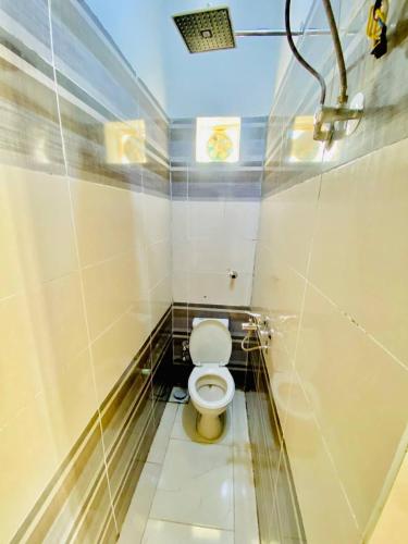 a small bathroom with a toilet in a stall at Dangy Kato in Aswan
