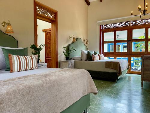 a bedroom with two beds in a room at Hotel Lago Valdivia in Jardin