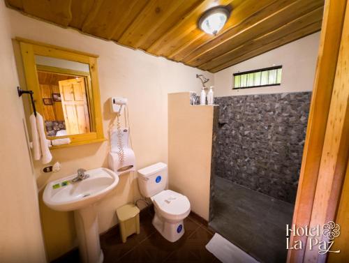 a bathroom with a sink and a toilet and a shower at Hotel La Paz in Poasito