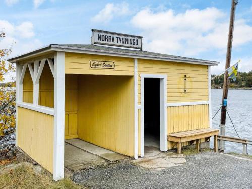 a yellow building with a sign on top of it at 4 star holiday home in VAXHOLM in Vaxholm