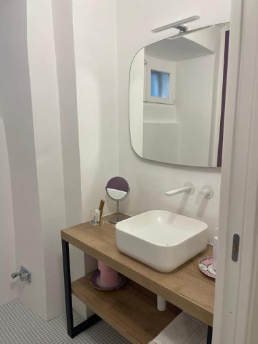 a bathroom with a white sink and a mirror at Principessa Isabella in Turin