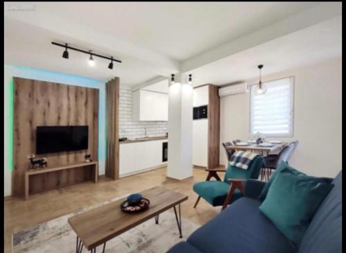 a living room with a blue couch and a table at Luxury Skopje Apartments in Skopje