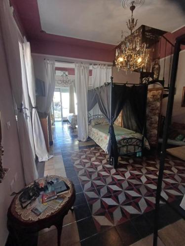 a bedroom with a bed and a table in a room at Romantic House spettacolare vista mare unica nel suo genere in Alghero