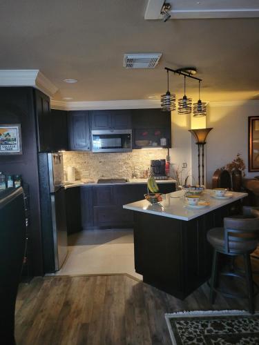 a kitchen with a island in the middle of a room at College Park-Orlando 5Star Villa Oasis - Home Away From Home - QUIET Neighborhood-PRIVATE Botanical Courtyard - mins from EOLA,DT, Winter Park - Free Parking & EV Plug In in Orlando