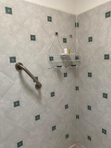 a bathroom with a shower with a shelf on the wall at Quinta Ángeles in Cuernavaca