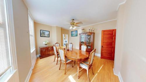 a dining room with a wooden table and chairs at ENTIRE Pittsburgh Home Close To Events - Kid Friendly - Designated Dog & Cat Areas - Private Patio - Free Parking - Fireplace in Pittsburgh