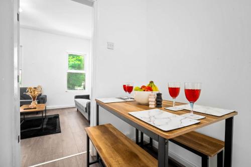 a dining room with wine glasses and a table at 1 Bed Apartment Birmingham Resorts World NEC BHX in Birmingham