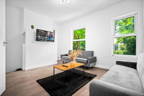 a living room with a couch and a table at 1 Bed Apartment Birmingham Resorts World NEC BHX in Birmingham