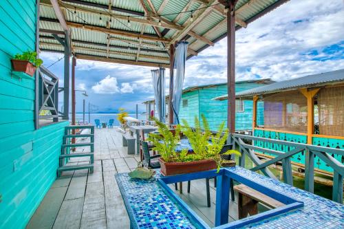 a blue building with tables and plants on it at Saigon Bay Bed & Breakfast in Bocas del Toro