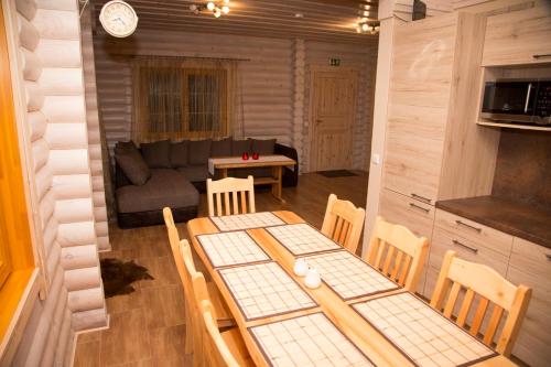 a living room with a table and chairs and a couch at Väike-Pärna Holiday Home in Otepää