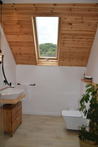 a bathroom with a sink and a window and a toilet at Famma House in Capu Piscului