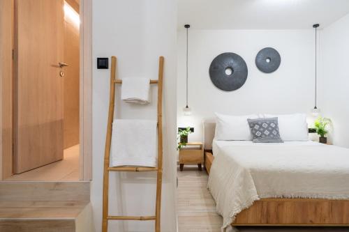 a bedroom with a bed and a mirror at Olea White in Skiathos Town