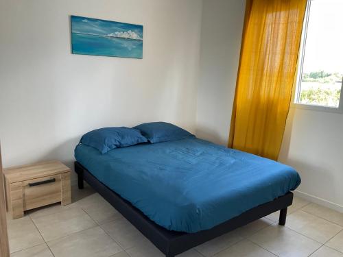 Ένα ή περισσότερα κρεβάτια σε δωμάτιο στο Résidence les villas bleues