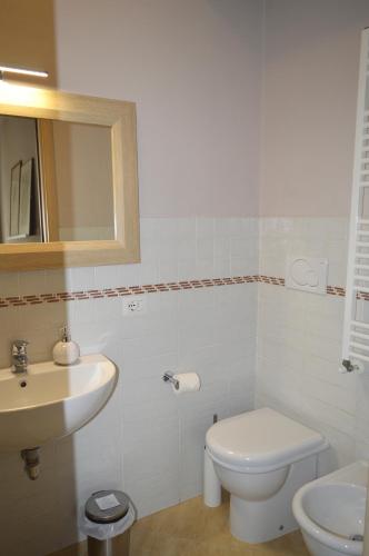 a bathroom with a white toilet and a sink at La Casetta tra Chianti e Firenze in Scandicci