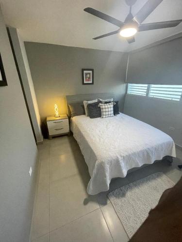 a bedroom with a bed and a ceiling fan at 3 Bedrooms Villa Close to Beaches and Atractions at Fajardo PR in Fajardo
