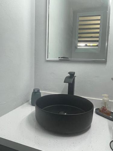 a bathroom with a black sink and a mirror at 3 Bedrooms Villa Close to Beaches and Atractions at Fajardo PR in Fajardo