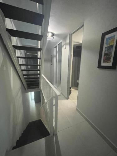 a hallway with a spiral staircase in a house at 3 Bedrooms Villa Close to Beaches and Atractions at Fajardo PR in Fajardo