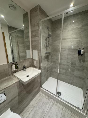 a bathroom with a shower and a sink at Kimpton Rooms Luxury Apartment By Luton Airport in Stopsley