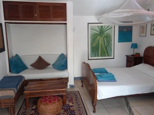 a room with two beds and a table in it at Bica da Salema Beach House in Salema