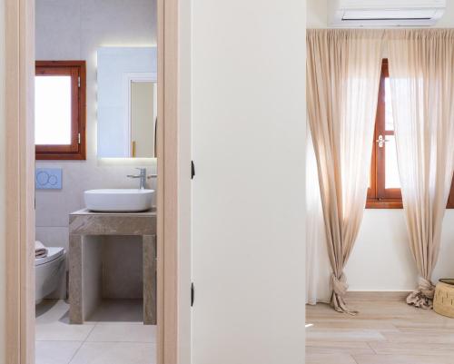 a bathroom with a sink and a toilet at Olea White in Skiathos Town