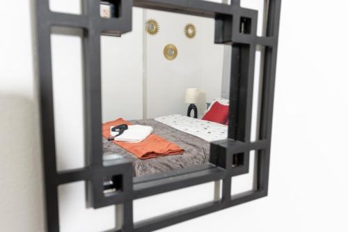a mirror reflection of a bedroom with a bed at Charming Private Studio-EnSuite & Kitchenette in Town centre Apartment in Lillington