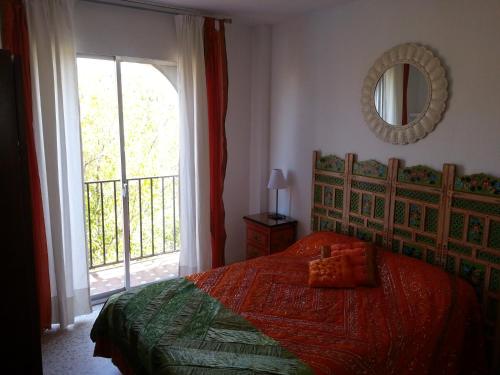 a bedroom with a bed and a large window at Preciosas vistas Alameda in Seville
