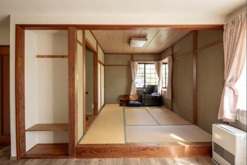 a living room with a view of a room at カナリアンホテル in Tateshina