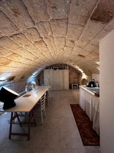 a large kitchen with a long table in a room at La Torre e il Mare Rooms by STHEY in Monopoli