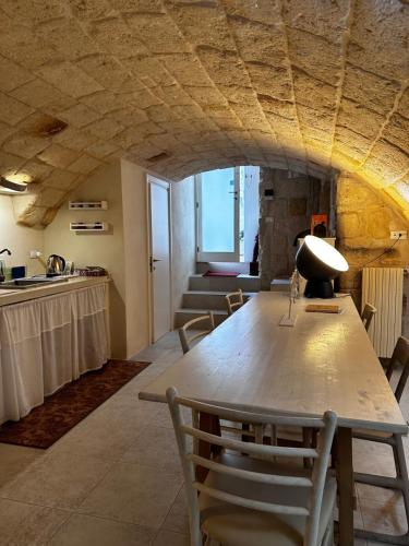 a living room with a large wooden table and chairs at La Torre e il Mare Rooms by STHEY in Monopoli