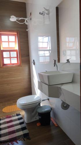 a bathroom with a sink and a toilet at suites montanha das letras in São Thomé das Letras