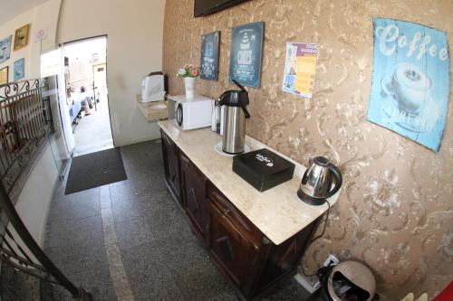 a room with a counter with a coffee maker on it at Hotel Maria da Fé in Aparecida