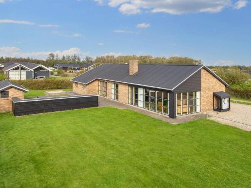 a house with a large lawn in front of it at Luxury Retreat by Fjord - By Traum Ferienwohnungen in Tarm