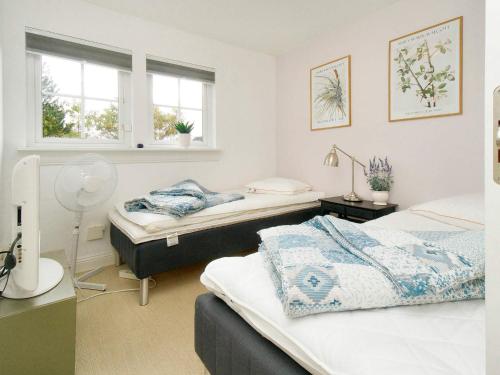 a bedroom with two beds and two windows at 4 star holiday home in Vejby-By Traum in Vejby