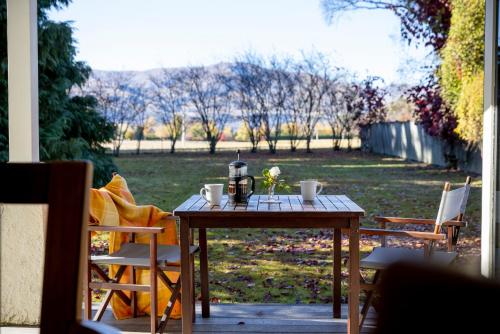 a table with a coffee maker on it on a patio at Willowbrook Country Apartments in Arrowtown