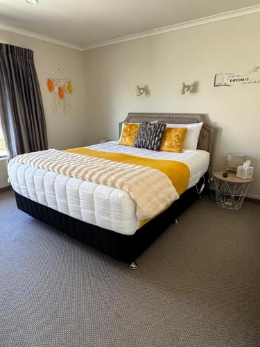 a bedroom with a large bed in a room at Centre Court Motel in Blenheim