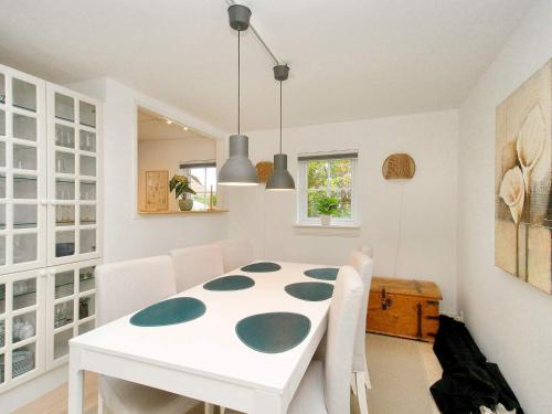a white dining room with a white table and chairs at 4 star holiday home in Vejby-By Traum in Vejby