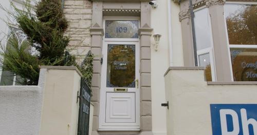 a white door of a house with a sign on it at Entire 8 Ensuite Bedroom Coastal Holiday Home Townhouse, Free Parking, Fully Equipped Kitchen, Dining Room & Lounge, Perfect for Family Gatherings, Long Term Contractor, Relocation, etc Stays, 20 mins to Sunderland & Newcastle, See our Site for Assurance in South Shields