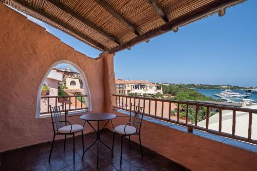 a balcony with two chairs and a view of the water at Cervo Hotel,Costa Smeralda Resort in Porto Cervo
