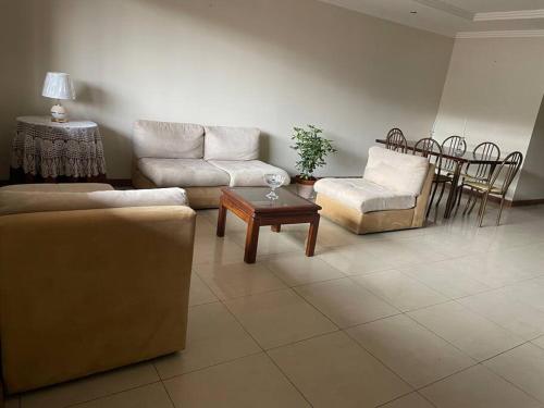 a living room with a couch and a table and chairs at Explora Cuenca desde este hogar! in Cuenca