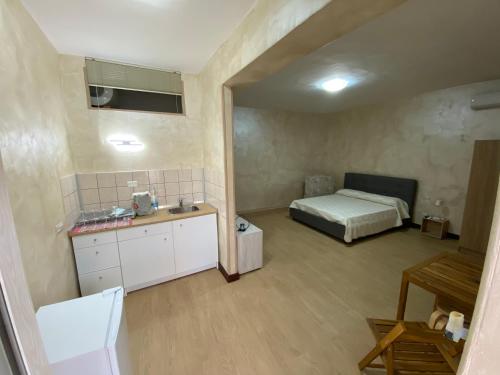 a bedroom with a bed and a sink in a room at Affitti brevi AeG CasinaVanvitelliana in Bacoli